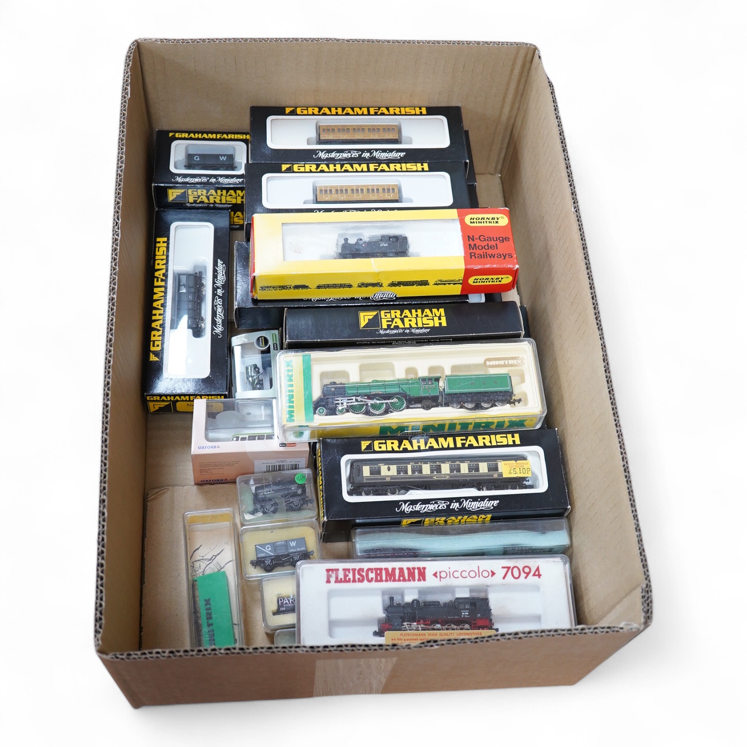 Twenty-eight boxed N gauge railway by Graham Farish, Minitrix, Fleischmann, etc. including four locomotives; an LNER class A3, Flying Scotsman (12950), a BR 0-6-0T, 47160 (N.201), a German DB 0-10-0T, 94 1730, (7094), an